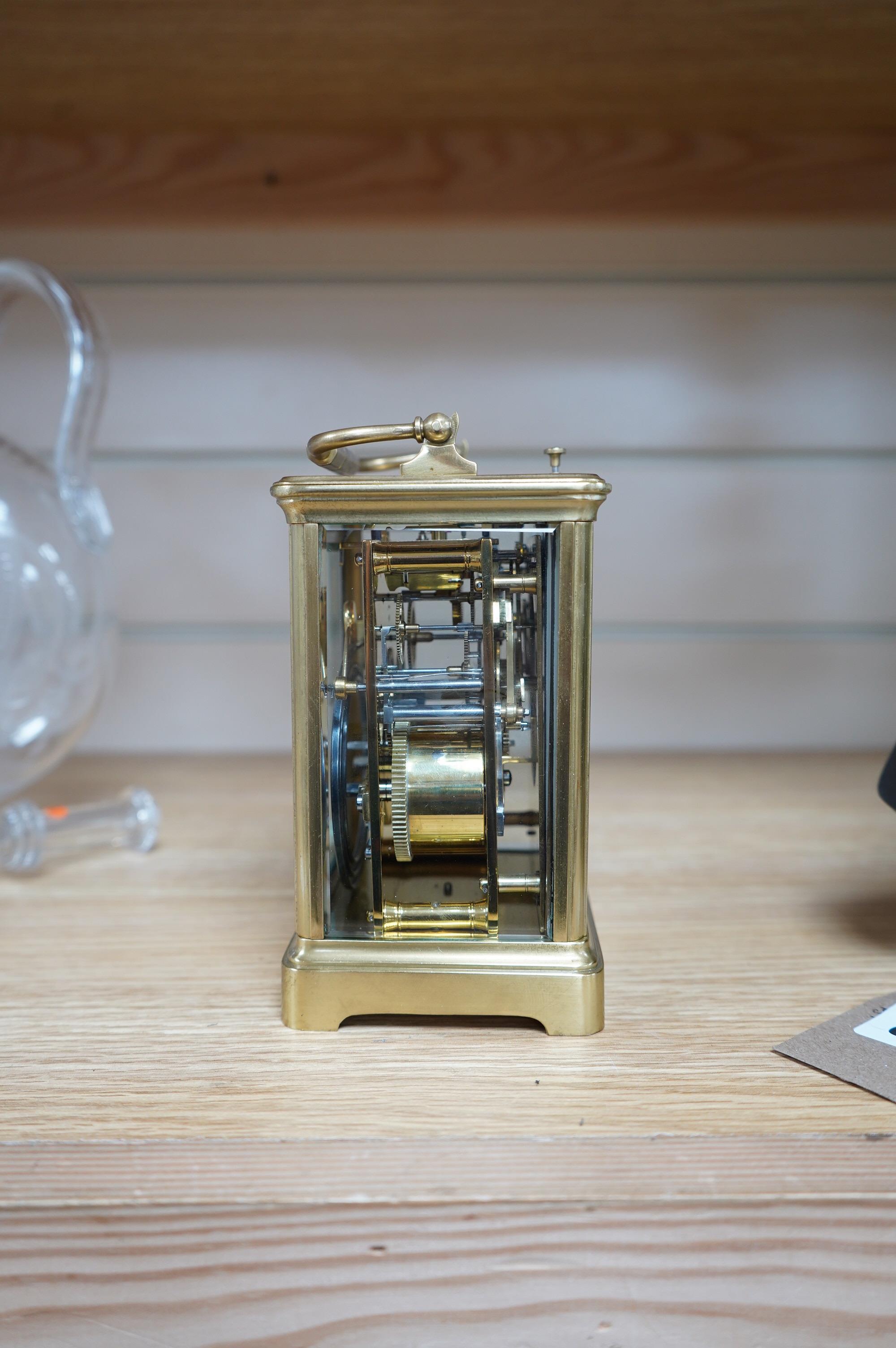 A brass cased repeating carriage clock, retailed by Edwards & Sons Ltd., no key, 15cm. Condition - fair to good, not tested